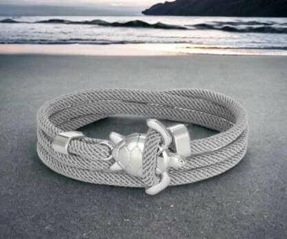 Sea Turtle Rope Bracelet with Silver/Black Charm Treat your wrist to a trendy nautical charm with the sea Turtle Rope Bracelet. This handcrafted accessory brings coastal vibes to any outfit. Key features/benefits: Adjustable rope bracelet with a polished