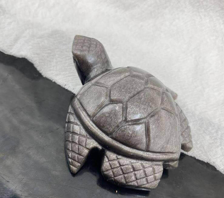 Natural Sea Turtle Quartz: Exquisite Sculpture Bring the magic of the sea into your home with this exquisite sea turtle sculpture carved from natural quartz crystal and silver obsidian. Hand-carved from natural stones for a one-of-a-kind work of art Stunn