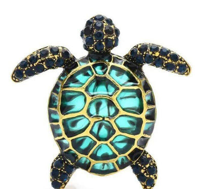 Colored Sea Turtle Hairpin Make a splashy fashion statement with the Colored Sea Turtle Hairpin! This handmade brooch features a playful sea turtle design available in black, dark green, and orange to match any outfit. Whimsical turtle design brings a fun