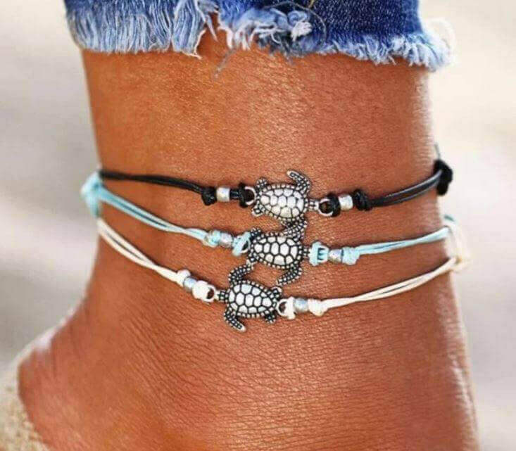 Sea Turtle Simple Anklet with Charm Add a touch of coastal charm to your look with the Sea Turtle Simple Anklet with Charm. This handmade anklet features a cute sea turtle charm that brings a fun, beachy vibe wherever you go. White, blue or black adjustab