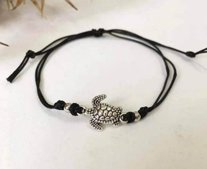 Sea Turtle Simple Anklet with Charm Add a touch of coastal charm to your look with the Sea Turtle Simple Anklet with Charm. This handmade anklet features a cute sea turtle charm that brings a fun, beachy vibe wherever you go. White, blue or black adjustab