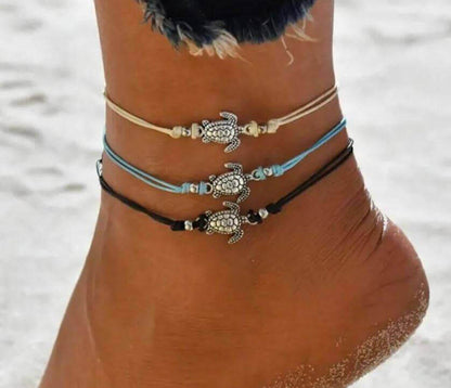 Sea Turtle Simple Anklet with Charm Add a touch of coastal charm to your look with the Sea Turtle Simple Anklet with Charm. This handmade anklet features a cute sea turtle charm that brings a fun, beachy vibe wherever you go. White, blue or black adjustab