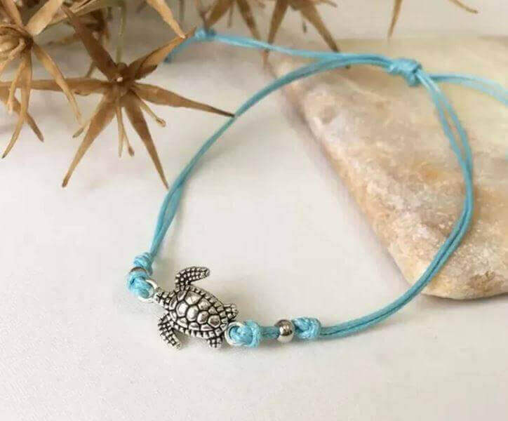 Sea Turtle Simple Anklet with Charm Add a touch of coastal charm to your look with the Sea Turtle Simple Anklet with Charm. This handmade anklet features a cute sea turtle charm that brings a fun, beachy vibe wherever you go. White, blue or black adjustab