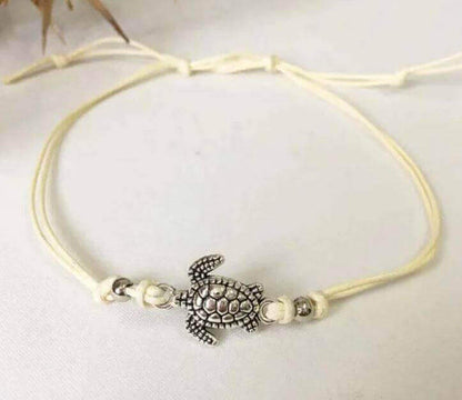 Sea Turtle Simple Anklet with Charm Add a touch of coastal charm to your look with the Sea Turtle Simple Anklet with Charm. This handmade anklet features a cute sea turtle charm that brings a fun, beachy vibe wherever you go. White, blue or black adjustab