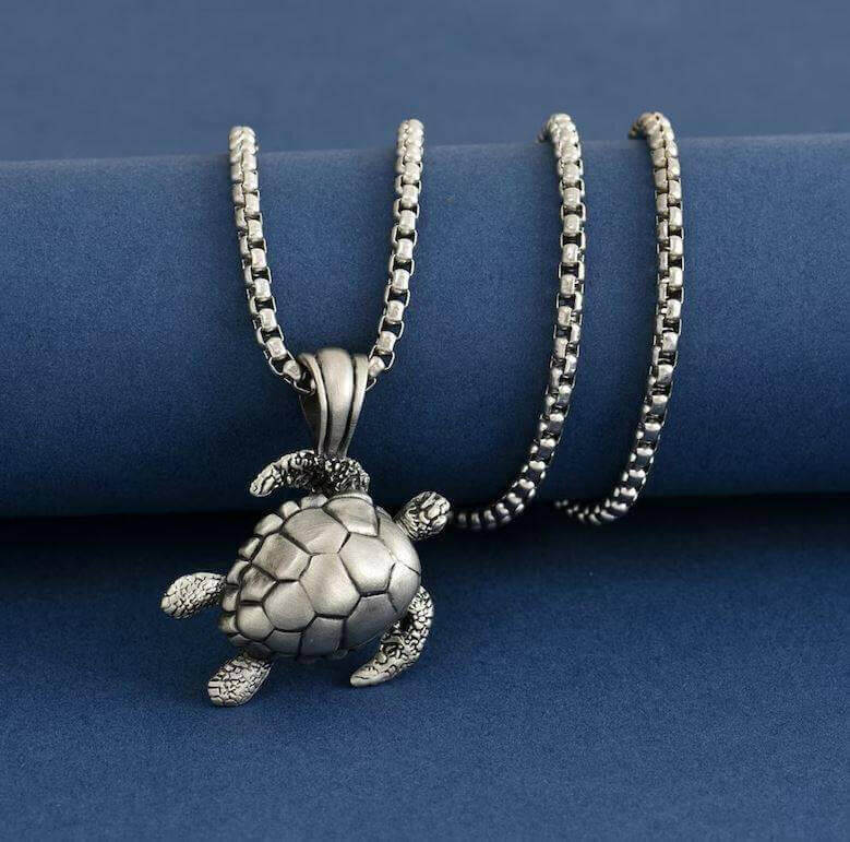 Handmade Sea Turtle Necklace with Charm For the turtle lover longing for the majestic sea - this handcrafted sea turtle necklace brings ocean magic around your neck. Key Features/Benefits Intricately engraved sea turtle pendant Large, statement turtle des