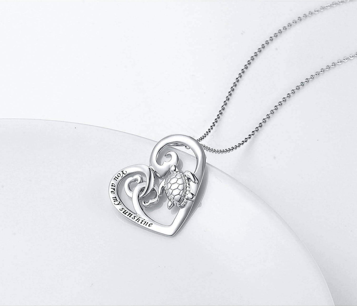 Sterling Silver Love Sea Turtle Necklace Capture the warmth of love with this Sterling Silver Love Sea Turtle Necklace. This stunning necklace features a polished sea turtle pendant facing towards the engraved "You Are My Sunshine" script to symbolize the