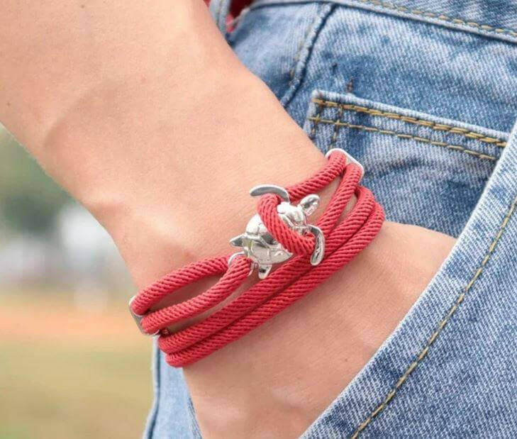 Sea Turtle Rope Bracelet with Silver/Black Charm Treat your wrist to a trendy nautical charm with the sea Turtle Rope Bracelet. This handcrafted accessory brings coastal vibes to any outfit. Key features/benefits: Adjustable rope bracelet with a polished