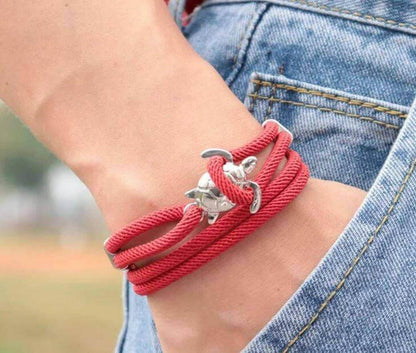 Sea Turtle Rope Bracelet with Silver/Black Charm Treat your wrist to a trendy nautical charm with the sea Turtle Rope Bracelet. This handcrafted accessory brings coastal vibes to any outfit. Key features/benefits: Adjustable rope bracelet with a polished