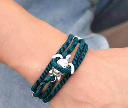 Sea Turtle Rope Bracelet with Silver/Black Charm Treat your wrist to a trendy nautical charm with the sea Turtle Rope Bracelet. This handcrafted accessory brings coastal vibes to any outfit. Key features/benefits: Adjustable rope bracelet with a polished