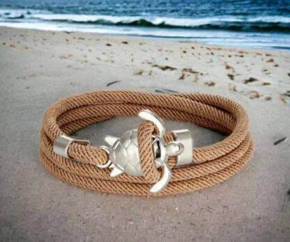 Sea Turtle Rope Bracelet with Silver/Black Charm Treat your wrist to a trendy nautical charm with the sea Turtle Rope Bracelet. This handcrafted accessory brings coastal vibes to any outfit. Key features/benefits: Adjustable rope bracelet with a polished