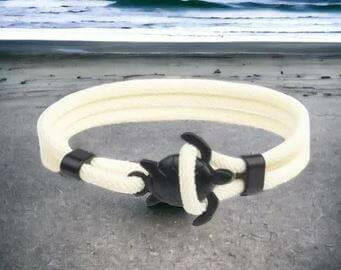 Sea Turtle Rope Bracelet with Silver/Black Charm Treat your wrist to a trendy nautical charm with the sea Turtle Rope Bracelet. This handcrafted accessory brings coastal vibes to any outfit. Key features/benefits: Adjustable rope bracelet with a polished