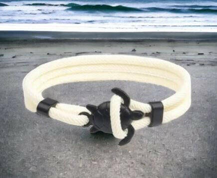 Sea Turtle Rope Bracelet with Silver/Black Charm Treat your wrist to a trendy nautical charm with the sea Turtle Rope Bracelet. This handcrafted accessory brings coastal vibes to any outfit. Key features/benefits: Adjustable rope bracelet with a polished