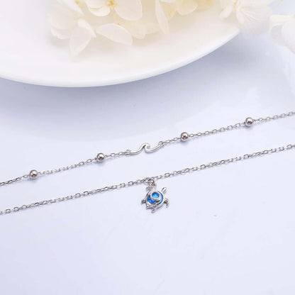 Sterling Silver Blue Stone Sea Turtle Bracelet Make a statement with this eye-catching Sterling Silver Blue Stone Sea Turtle Bracelet. This stunning bracelet features a polished silver band accented with a vibrant blue stone carved into an elegant sea tur