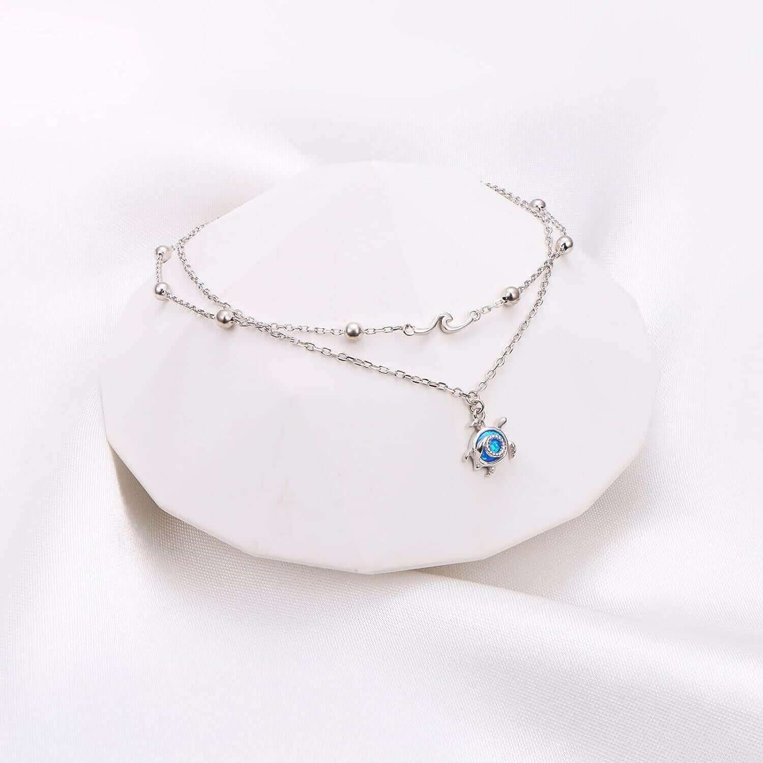 Sterling Silver Blue Stone Sea Turtle Bracelet Make a statement with this eye-catching Sterling Silver Blue Stone Sea Turtle Bracelet. This stunning bracelet features a polished silver band accented with a vibrant blue stone carved into an elegant sea tur