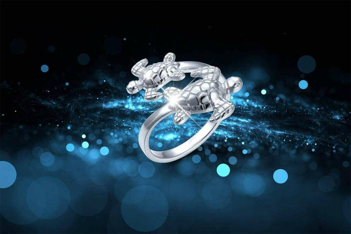 Double Sea Turtle Sterling Silver Ring Dive into luxury with the Sterling Silver Double Sea Turtle Ring. Handcrafted from 925 hypoallergenic sterling silver for timeless beauty Platinum plating ensures lasting shine without irritation Two sea turtles desi